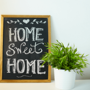 an image showing a black board with the words 'home sweet home' written in white chalk