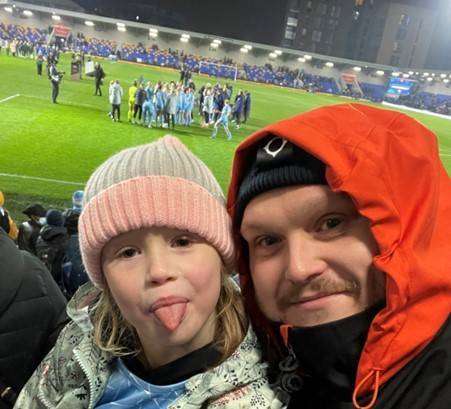 Picture of stroke survivor Dan with his daughter at a football match