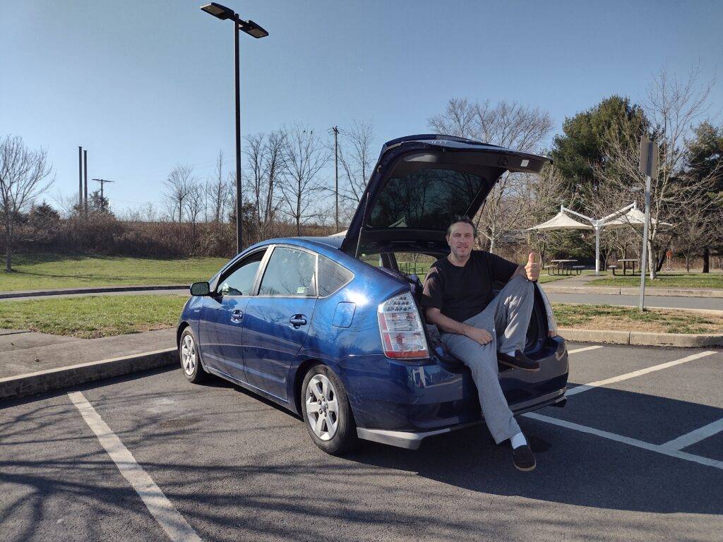 Stroke survivor Joe sitting at the back of his car