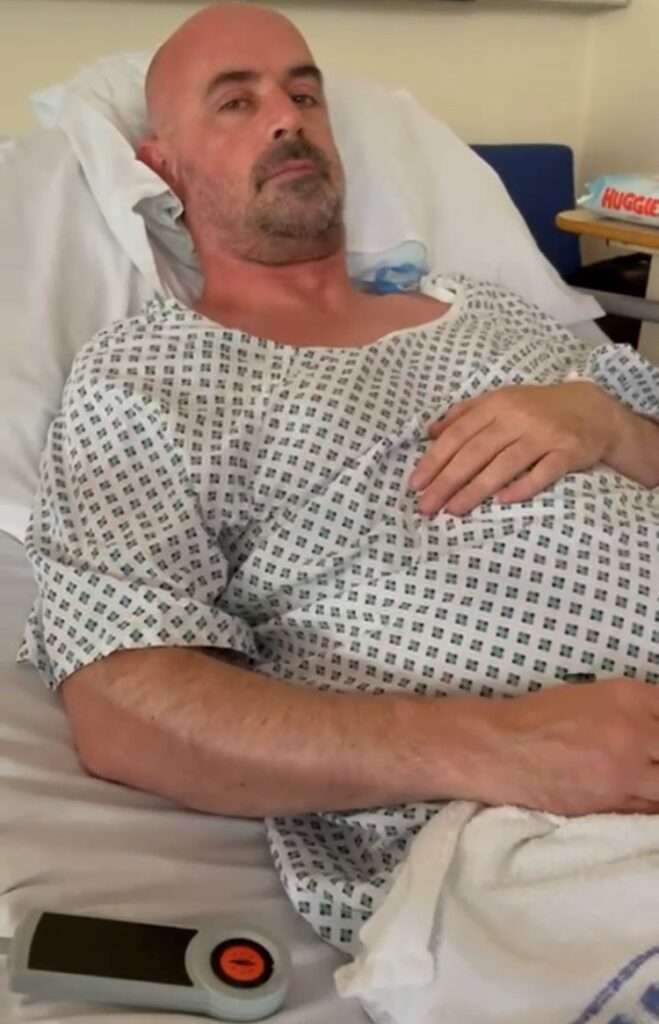 Picture of Andy who survived at stroke at just 44 in a hospital bed
