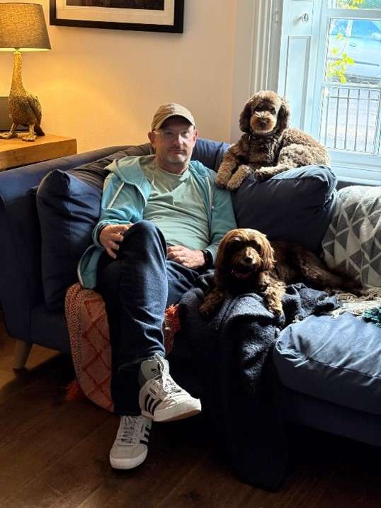 Picture of Rob who survived an ischaemic stroke at 52 with his pet dogs