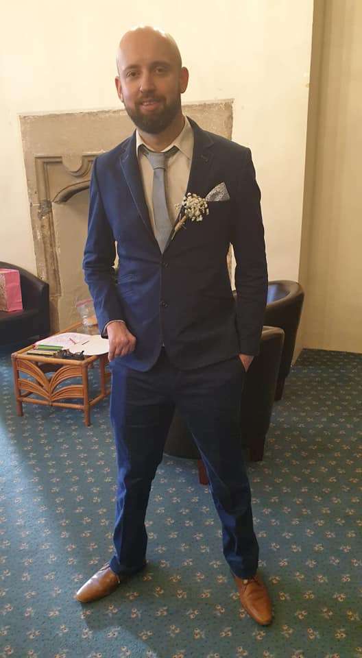 Picture of Jeremy in a suit years after he survived a haemorrhagic stroke at just four years old causing right sided hemiplegia and aphasia