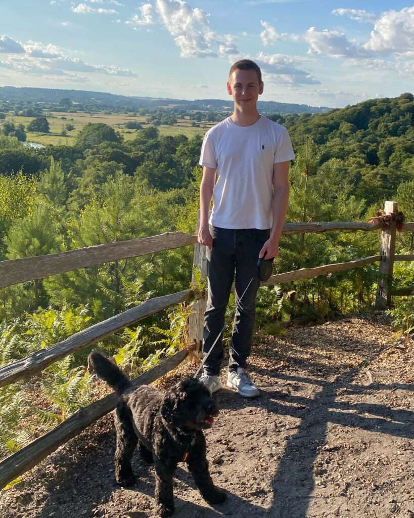 Picture of Sam who survived an ischaemic stroke aged just 4 growing up after stroke with his dog