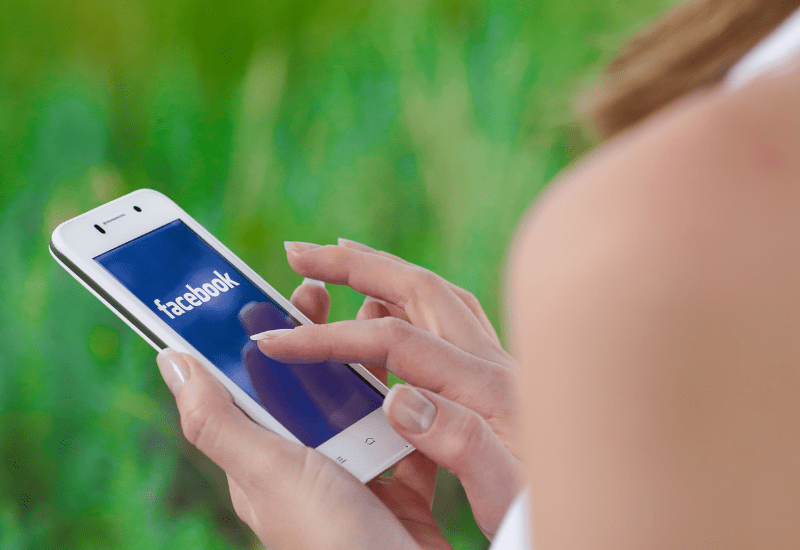 Picture of a stroke survivor joining the Different Strokes Facebook group on their phone for support