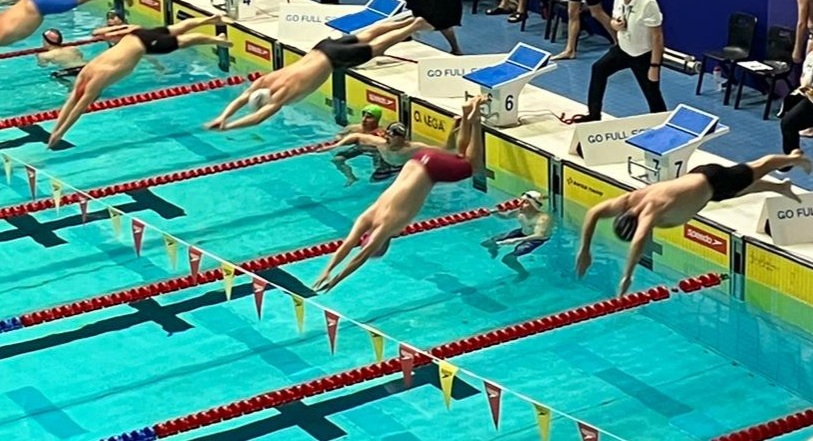 Picture of Richard who survived a stroke at 48 at a swimming competition in the red trunks